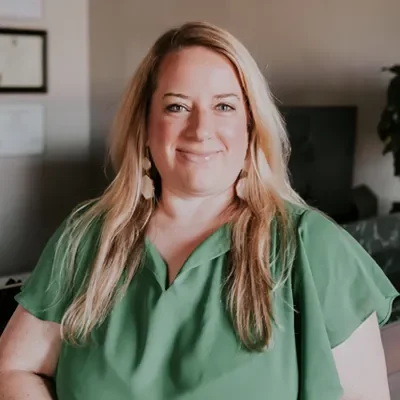 Front Desk Receptionist Kim Smiling In Green Top