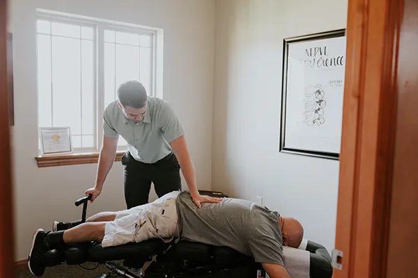 Chiropractor Cory Madison Adjusting Patient