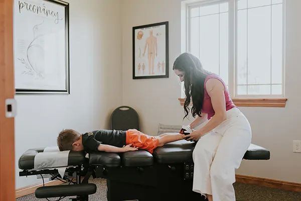 Chiropractor Kallie Madison Adjusting Child