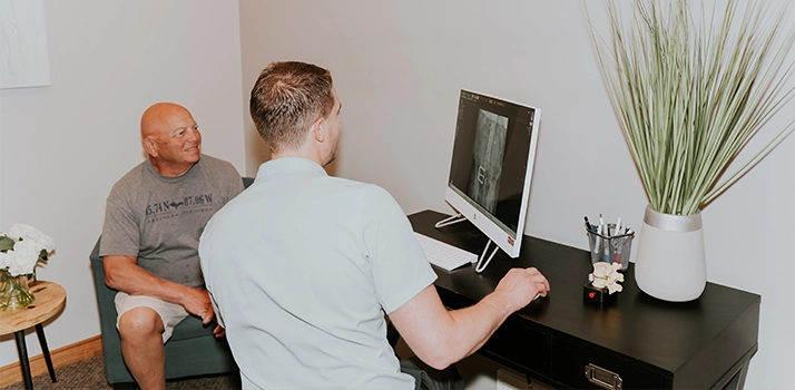 Cory Madison Consulting With Patient Over X-Ray